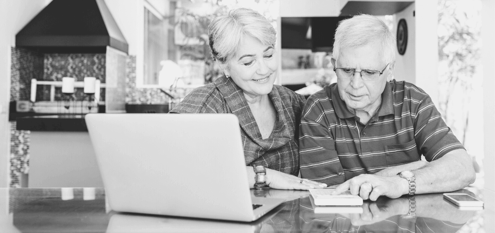 an elderly couple looks over their retirement funds together