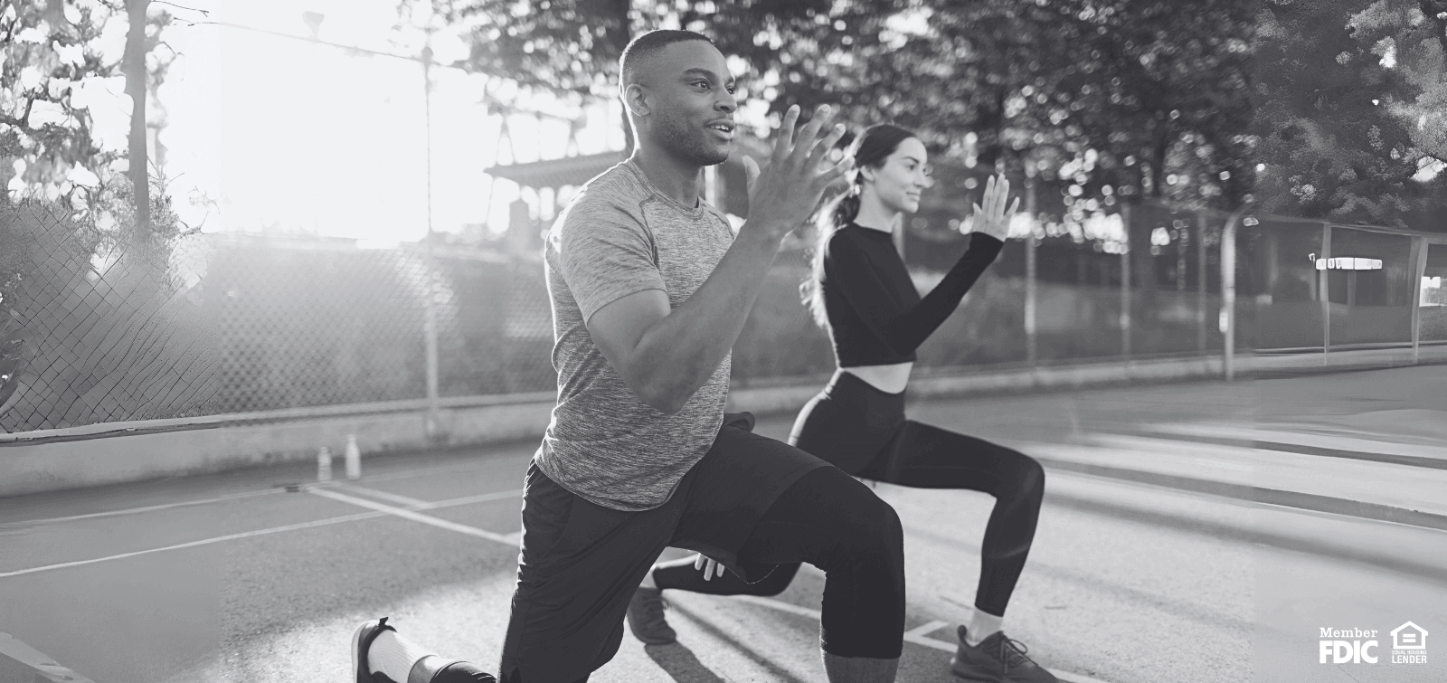 a man and woman exercising on an outdoor court