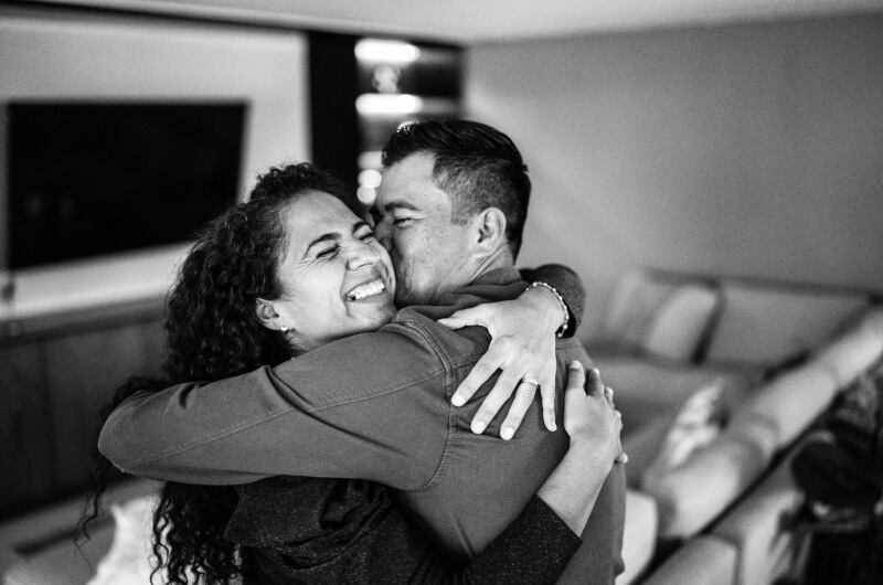 Couple smiling in an embrace in their living room
