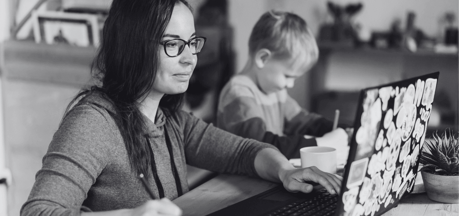 a mom fills out a personal military loan application on her laptop