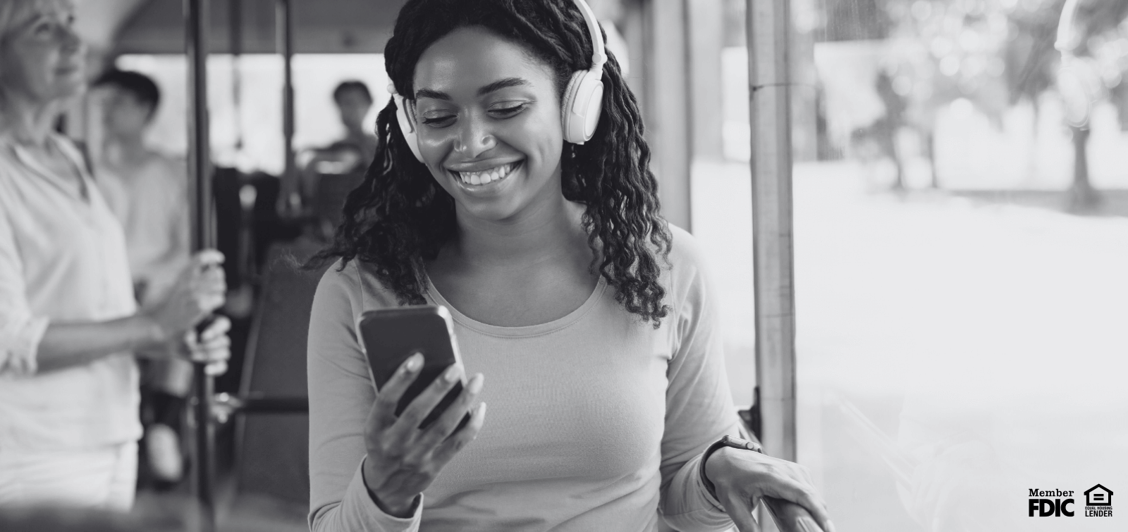 a young woman enjoys mobile banking on the bus