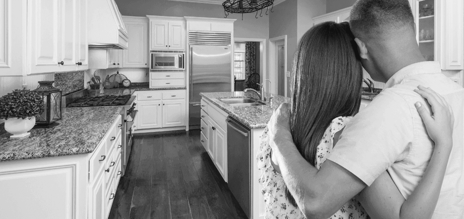 a couple looks at their newly remodeled kitchen
