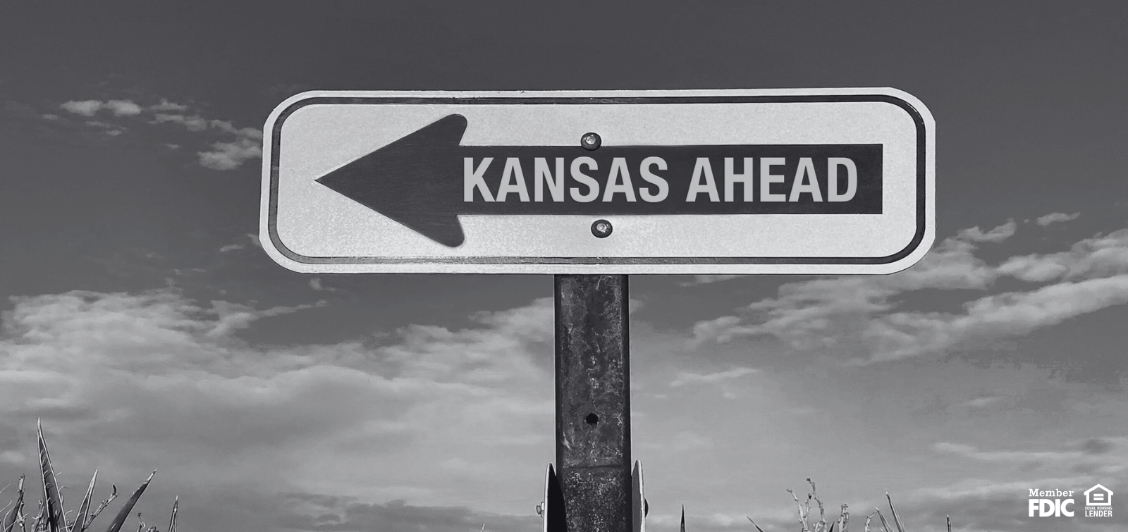 a sign pointing the way to Kansas
