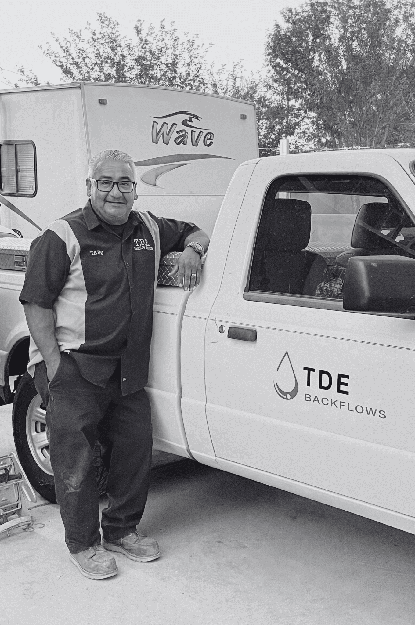 TDE Backflow owner standing next to a work truck