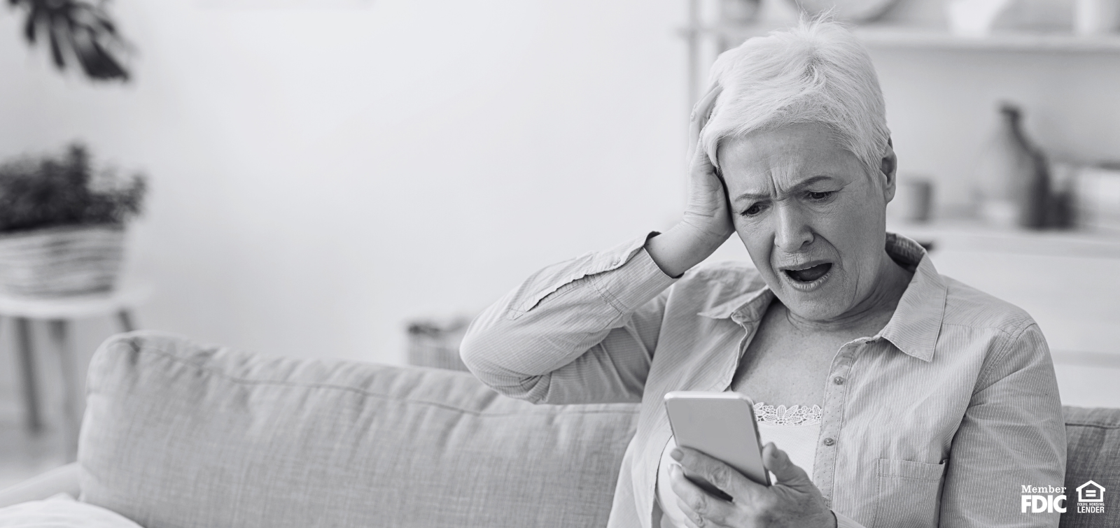 Elderly woman holds head in anguish because she's fallen prey to a text scam.